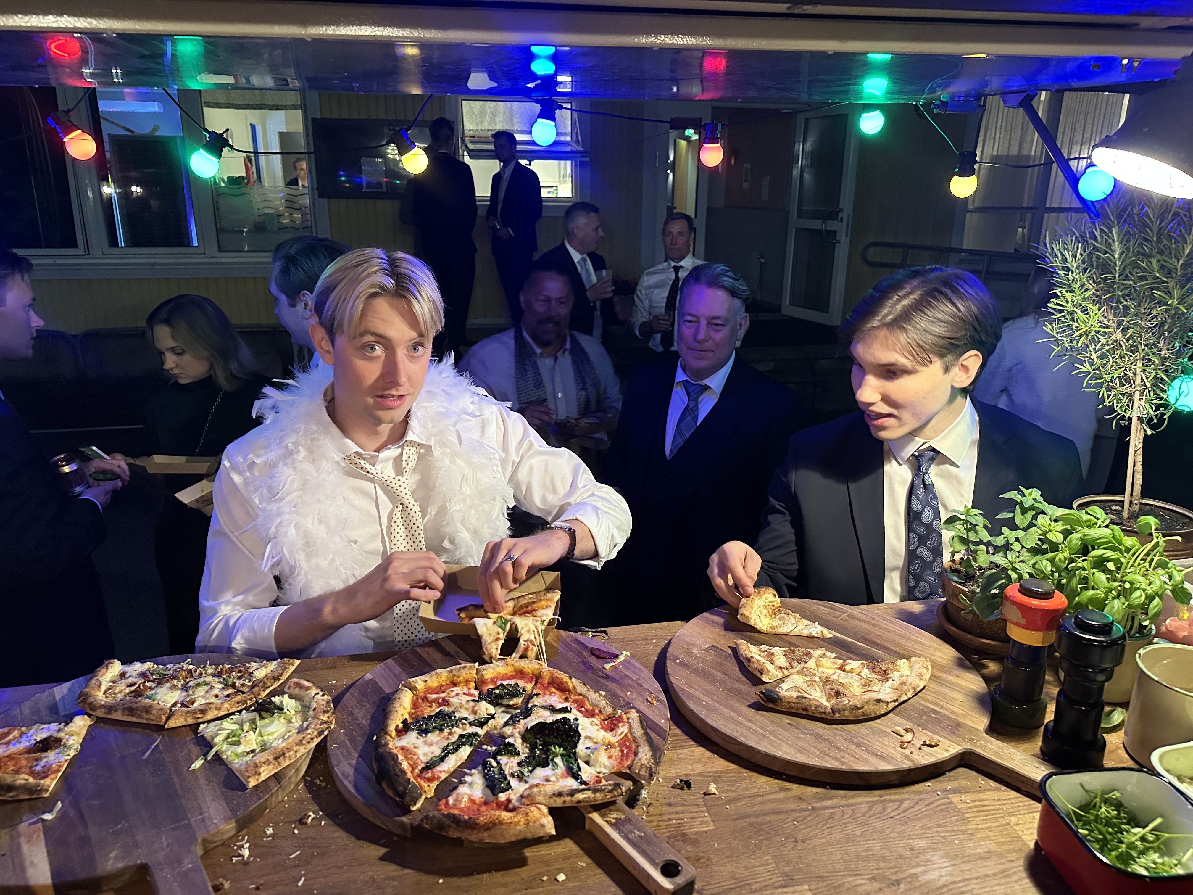 Gäster som äter pizza vid ett kvällsevent